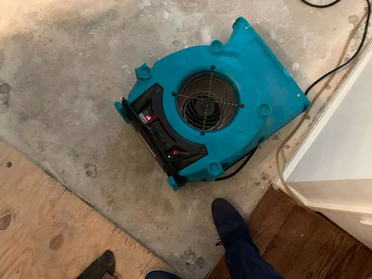 Air mover drying subfloor during Commercial Water Damage Restoration in Ville Platte